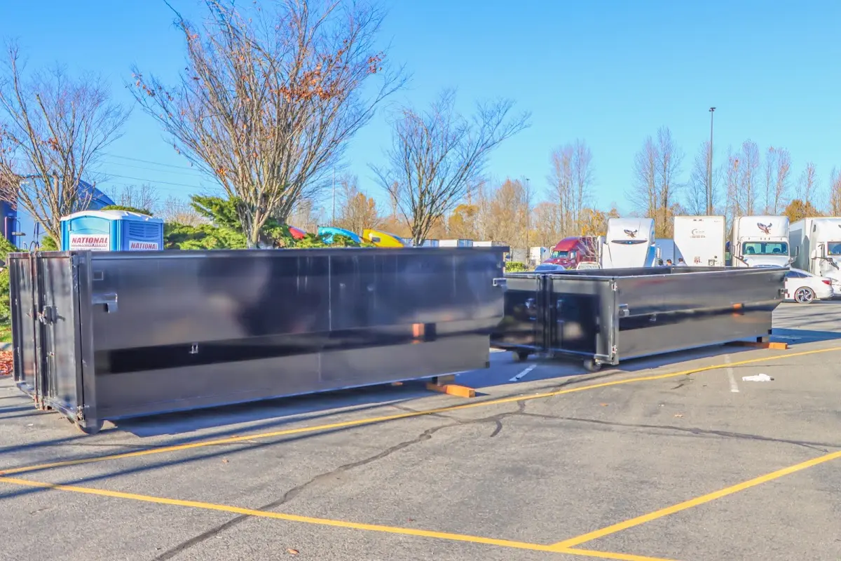 Professional dumpster rental service with roll-off container on residential driveway in Shrewsbury